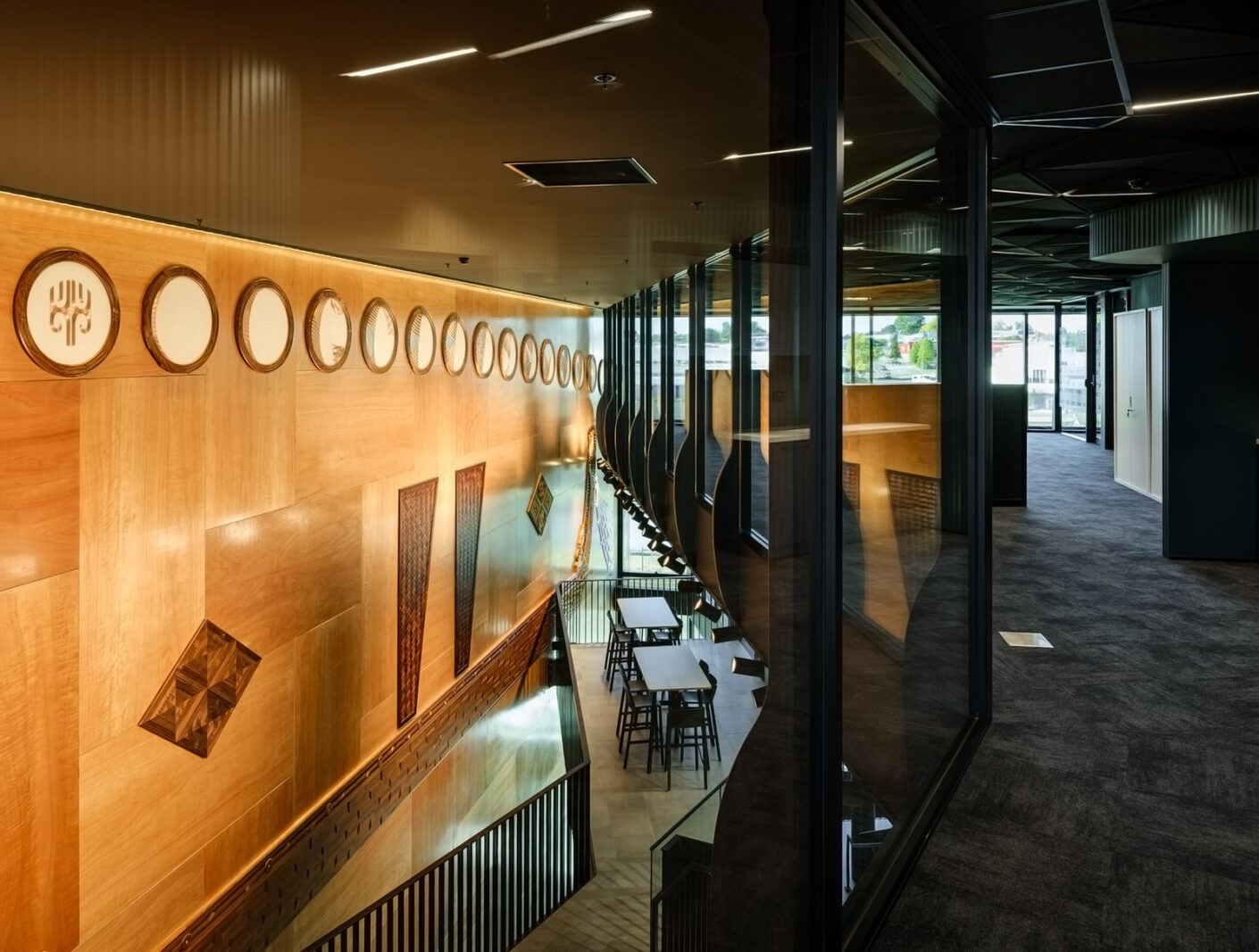 Internal photo of He Whare Hono ō Tūwharetoa showing artwork on wall and walkways.